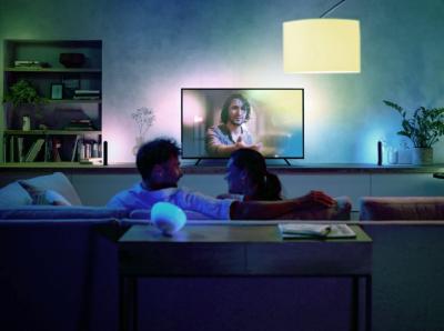 two people watching television with mood lighting
