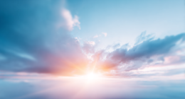 Sun peeking through clouds in a blue sky