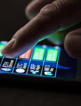 hand scrolling cryptocurrency information on a phone