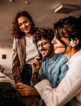 People working together on the phone and around a screen