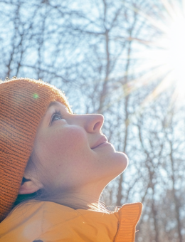 Person in a forest with the sun shining